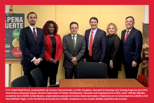 Foto del grupo ejecutivo de la Universidad parados detras de una mesa